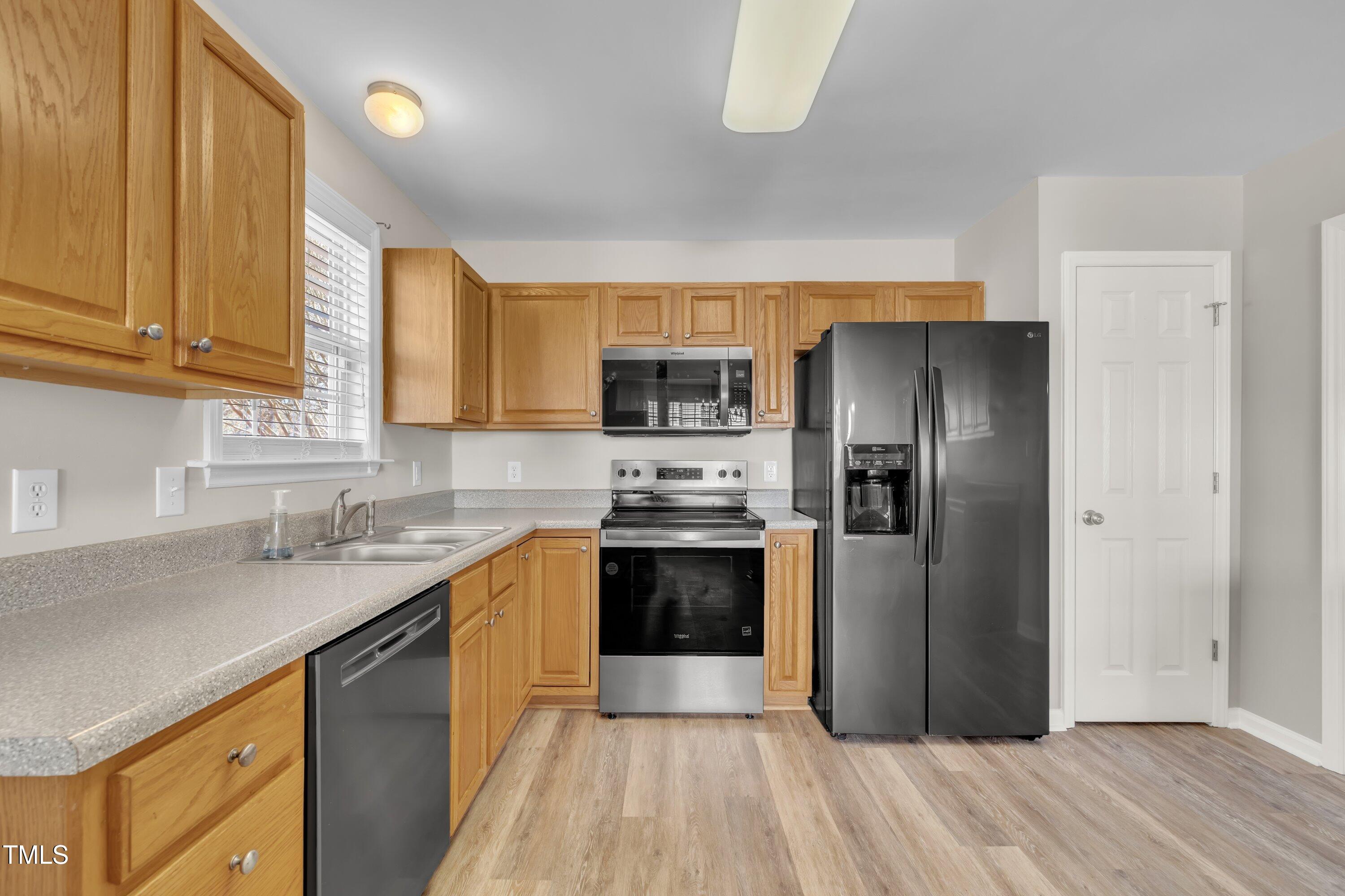 147 Tralee Drive Smithfield, NC 27577 - Photo 28 of 43 a kitchen with stainless steel appliances granite countertop a refrigerator and a sink