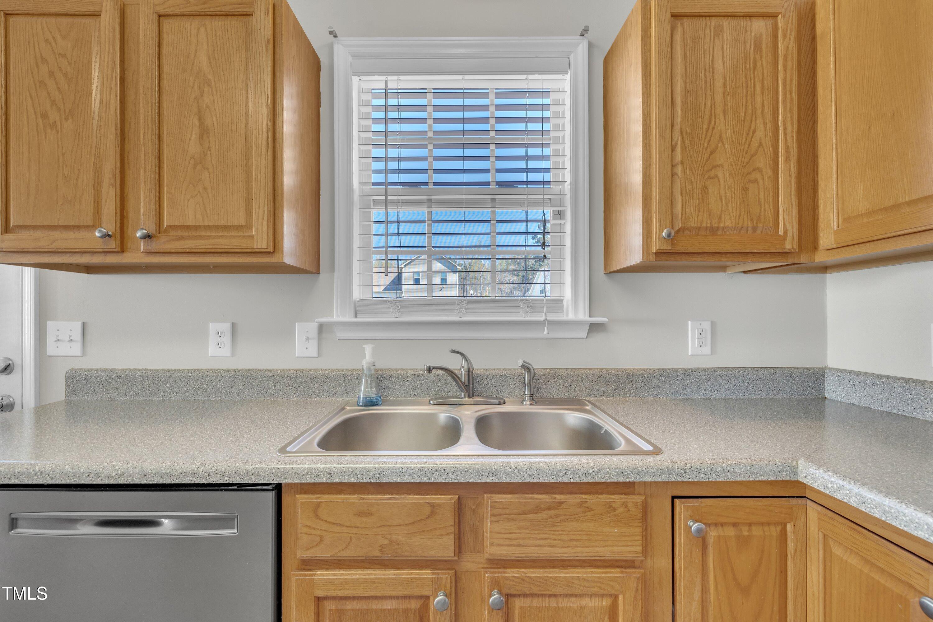 147 Tralee Drive Smithfield, NC 27577 - Photo 31 of 43 a kitchen with stainless steel appliances granite countertop a sink and a white cabinets