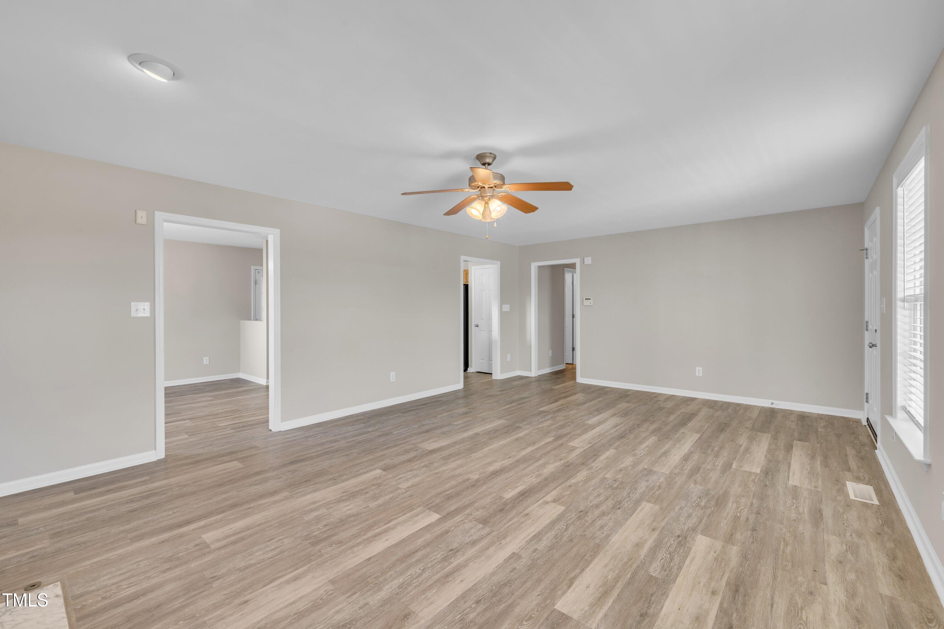 147 Tralee Drive Smithfield, NC 27577 - Photo 7 of 43 wooden floor in an empty room with a window