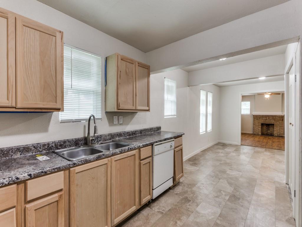 a kitchen with stainless steel appliances granite countertop a sink and cabinets with granite countertops