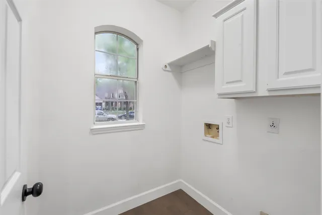 a view of a small space with wooden floor and entryway