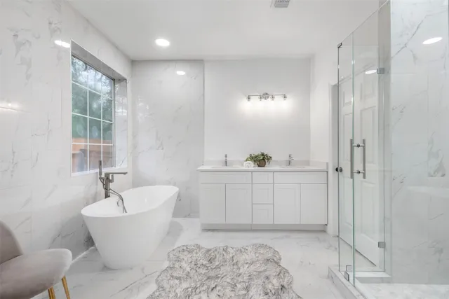 a spacious bathroom with a shower sink and mirror