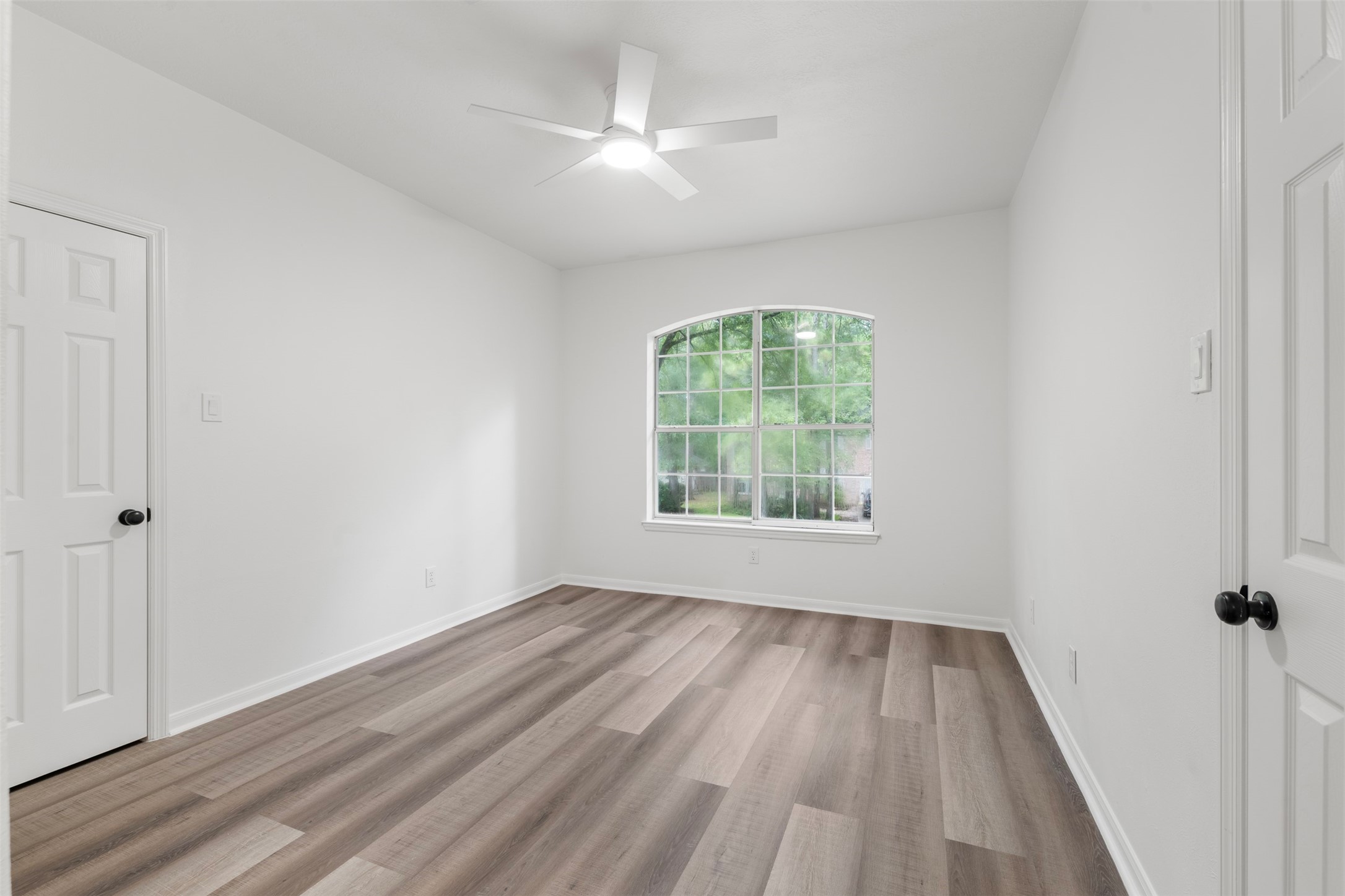55 Terraglen Drive Spring, TX 77382 - Photo 19 of 32 wooden floor in an empty room with a window