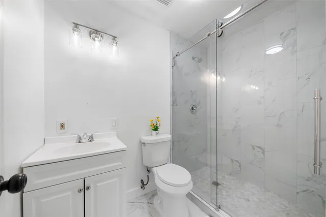 a bathroom with a sink toilet and shower