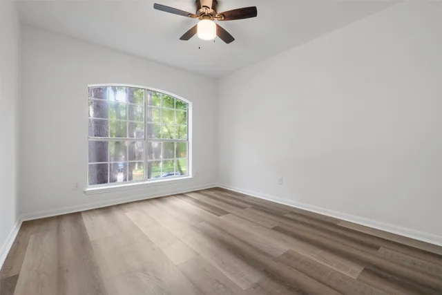 a view of a house with a backyard and a tree
