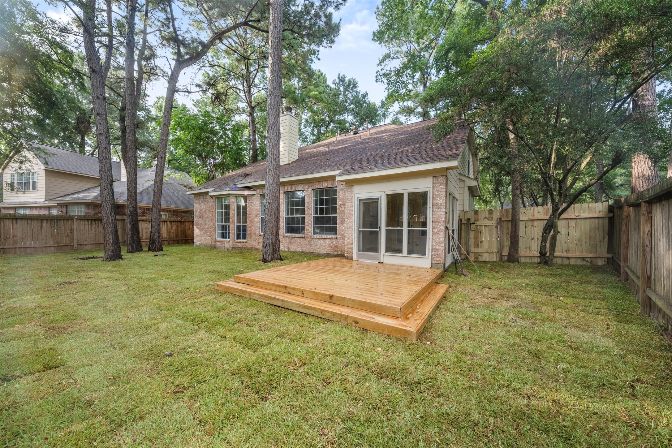 55 Terraglen Drive Spring, TX 77382 - Photo 25 of 32 a view of a house with a backyard and a tree