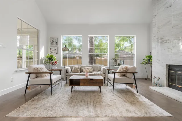 a living room with furniture and a fireplace