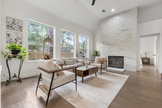a living room with furniture a window and a fireplace