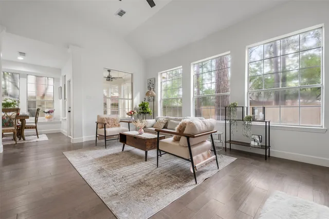 a living room with furniture and a wooden floor
