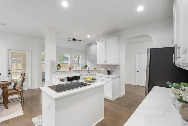 a kitchen that has a lot of cabinets in it and appliances