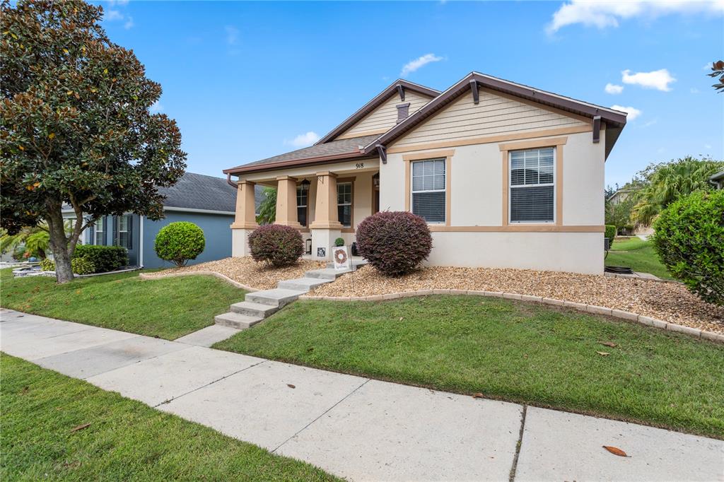 a front view of a house with yard and tree