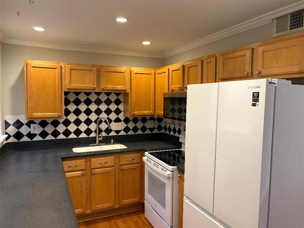 1647 Briarcliff Road Northeast, Unit 1 Atlanta, GA 30306 - Photo 3 of 11 a kitchen with sink refrigerator and cabinets