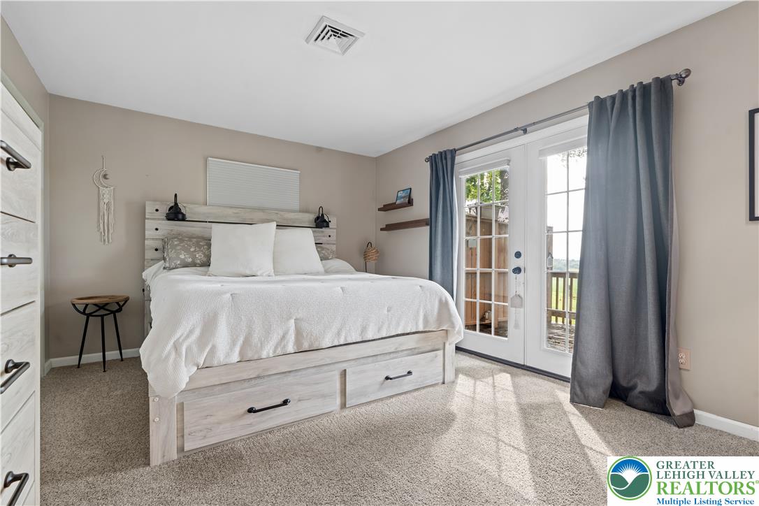 2569 Woods Edge Road Bath, PA 18014 - Photo 15 of 40 Double doors open to the outdoors in this cozy carpeted bedroom.