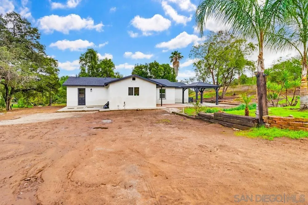15751 Lyons Valley Road Jamul, CA 91935 - Photo 2 of 59 a view of house with backyard and trees