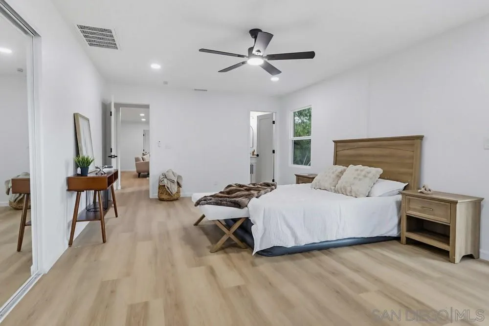 15751 Lyons Valley Road Jamul, CA 91935 - Photo 21 of 59 a spacious bedroom with a bed and a table