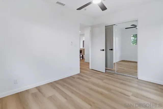 a view of a livingroom with wooden floor and closet