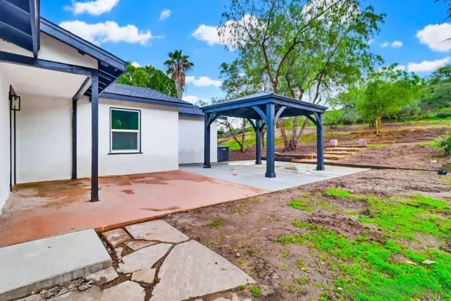 a white house that has a tree in it