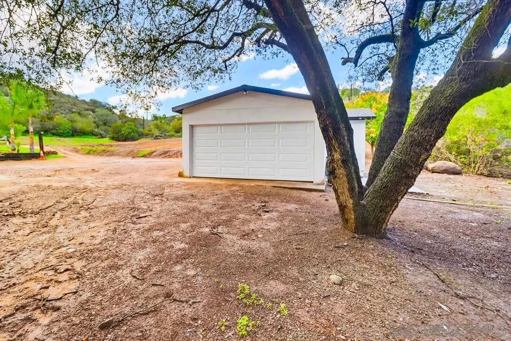 15751 Lyons Valley Road Jamul, CA 91935 - Photo 47 of 59 a view of a house with backyard and tree