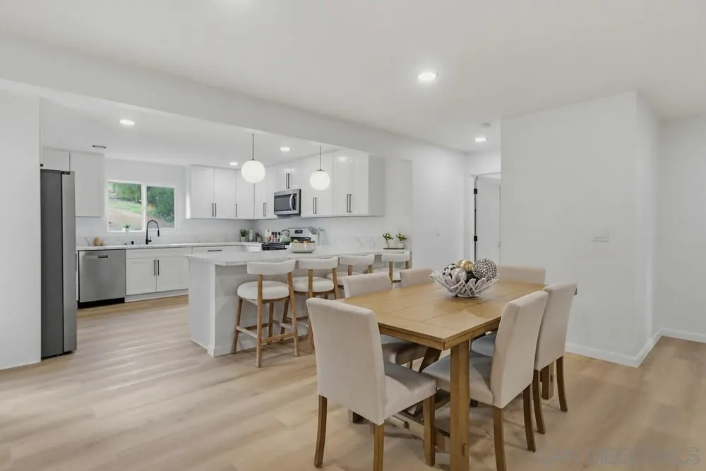 15751 Lyons Valley Road Jamul, CA 91935 - Photo 7 of 59 a kitchen with a dining table chairs and wooden floor