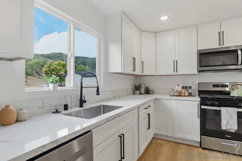 15751 Lyons Valley Road Jamul, CA 91935 - Photo 10 of 59 a kitchen with a sink stove and microwave
