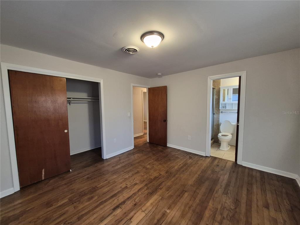 4004 Southwest 22nd Street Ocala, FL 34474 - Photo 7 of 9 a view of an empty room with wooden floor and closet