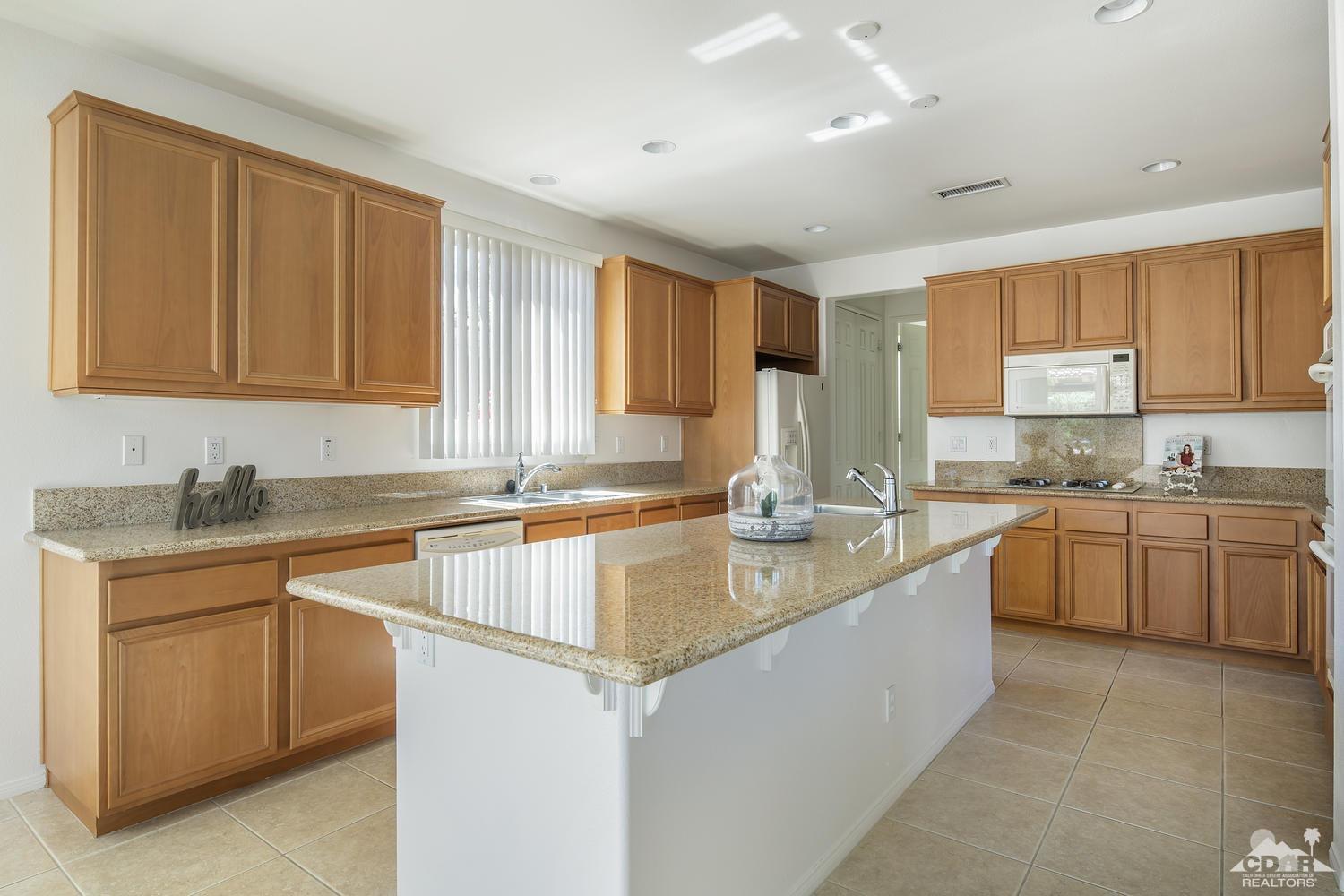 36 Shoreline Drive Rancho Mirage, CA 92270 - Photo 11 of 38 a kitchen with stainless steel appliances granite countertop a sink stove and cabinets