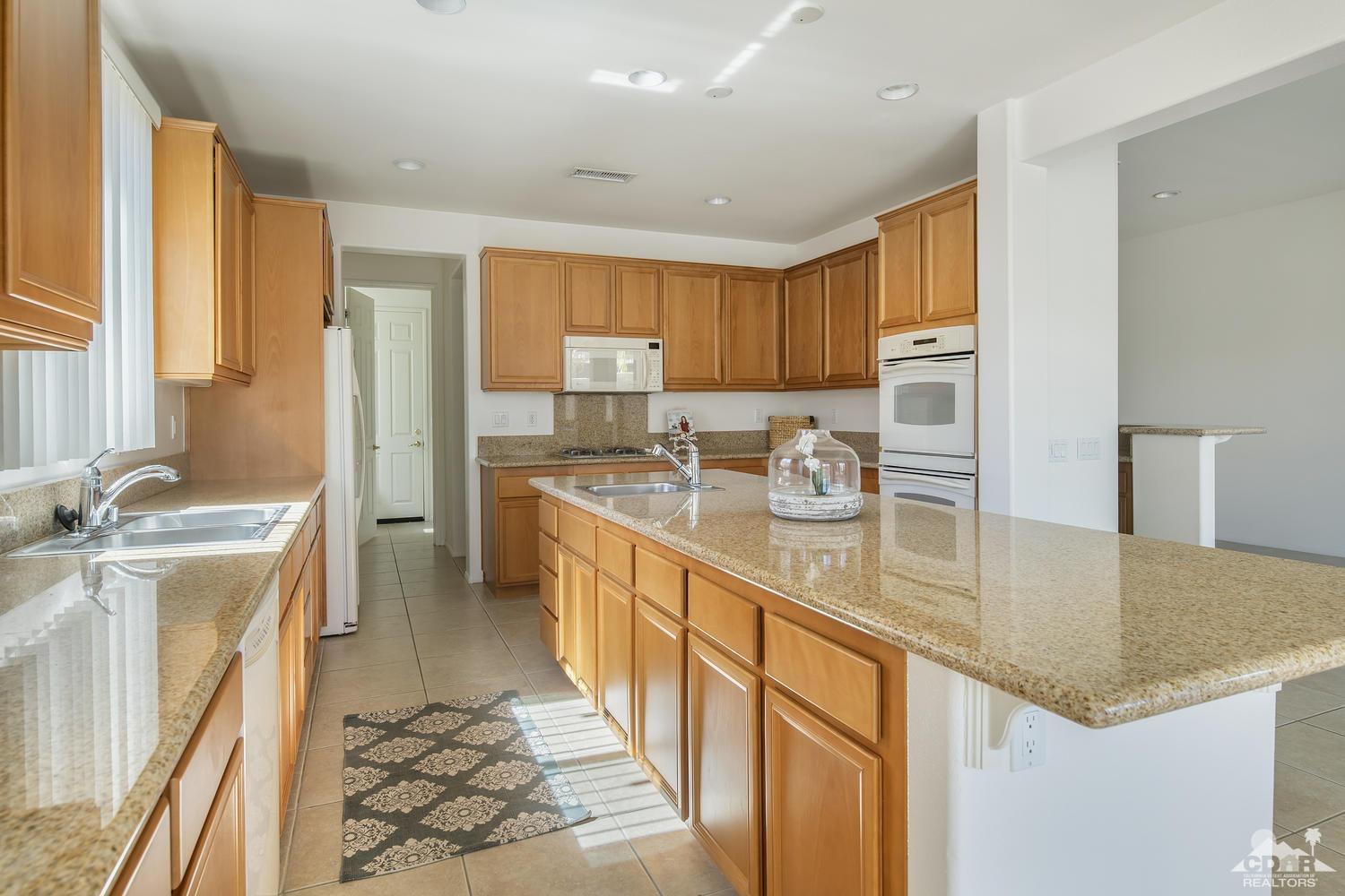 36 Shoreline Drive Rancho Mirage, CA 92270 - Photo 14 of 38 a kitchen with stainless steel appliances granite countertop a sink a stove and a refrigerator