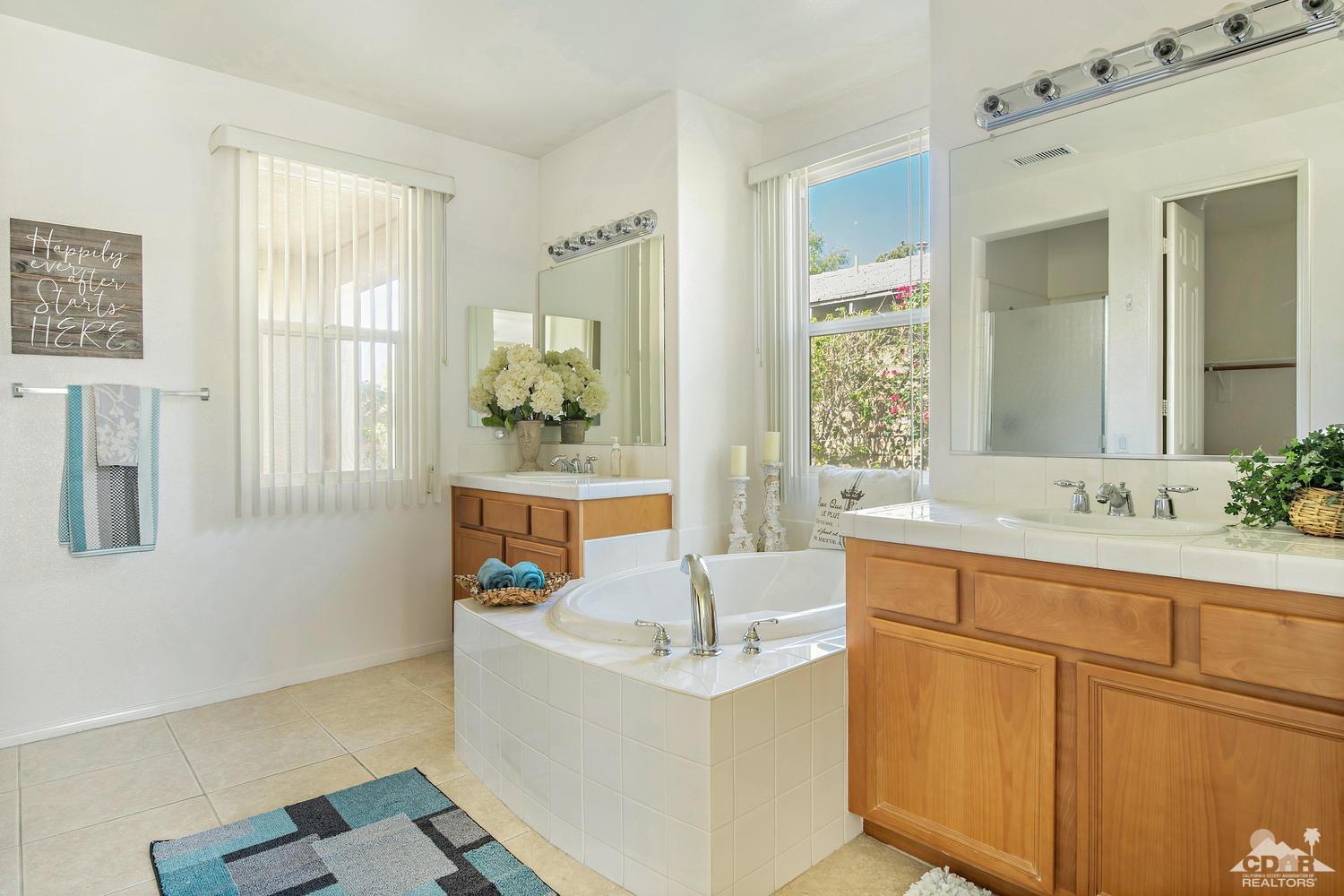 36 Shoreline Drive Rancho Mirage, CA 92270 - Photo 21 of 38 a bathroom with a tub sink and mirror