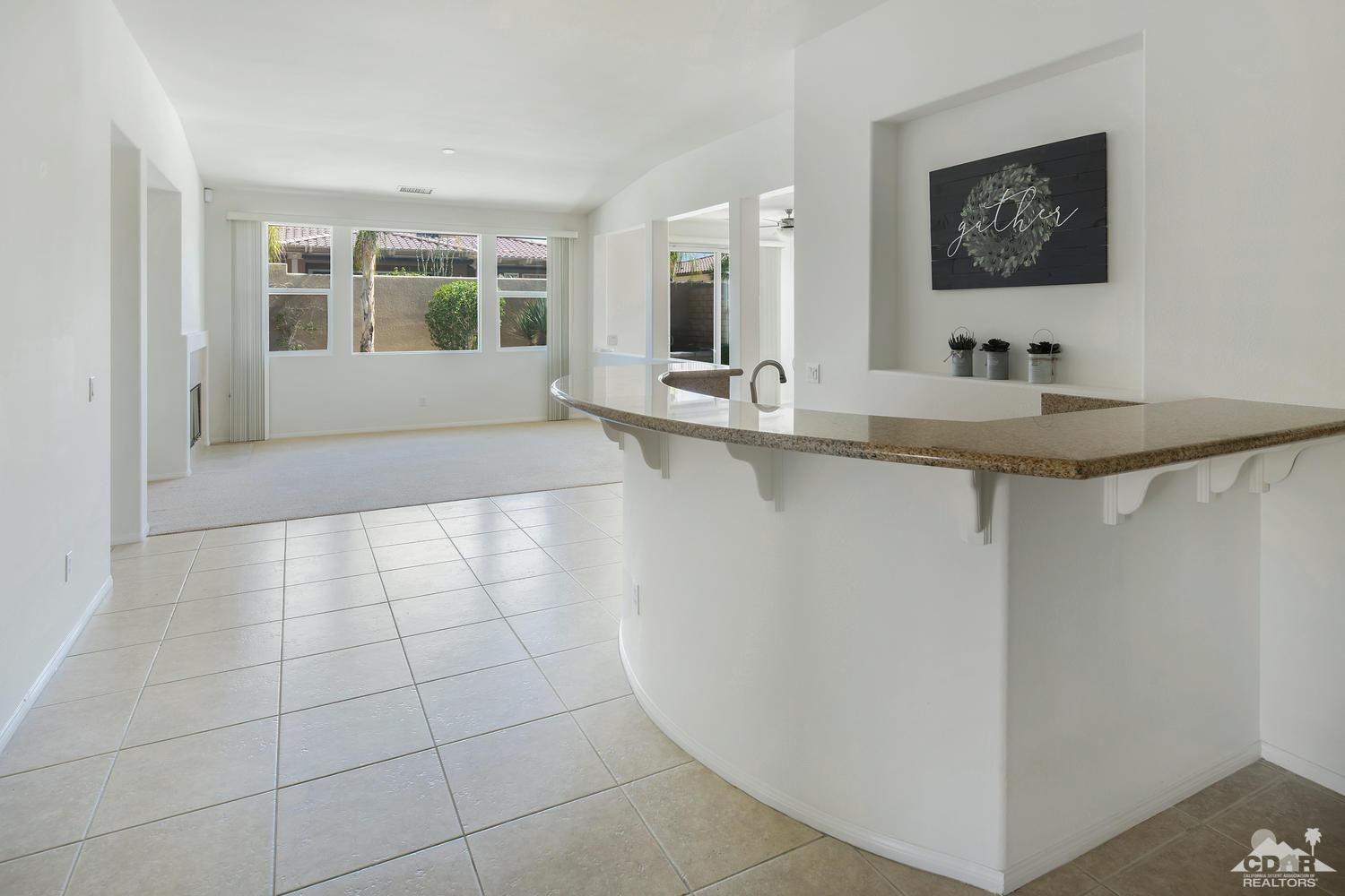 36 Shoreline Drive Rancho Mirage, CA 92270 - Photo 7 of 38 a view of a kitchen with a sink and a mirror