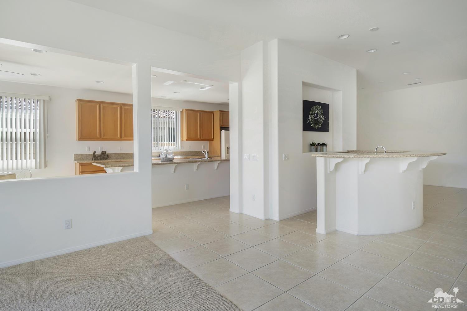 36 Shoreline Drive Rancho Mirage, CA 92270 - Photo 9 of 38 a view of a kitchen with a sink dishwasher and a refrigerator
