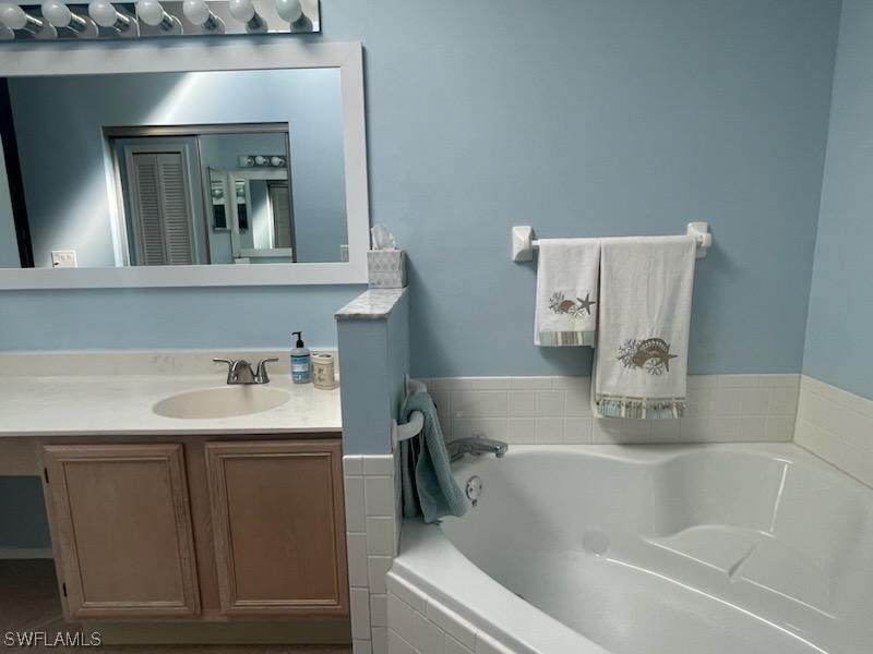 20918 Country Barn Drive Estero, FL 33928 - Photo 32 of 48 a bathroom with a bathtub sink and mirror