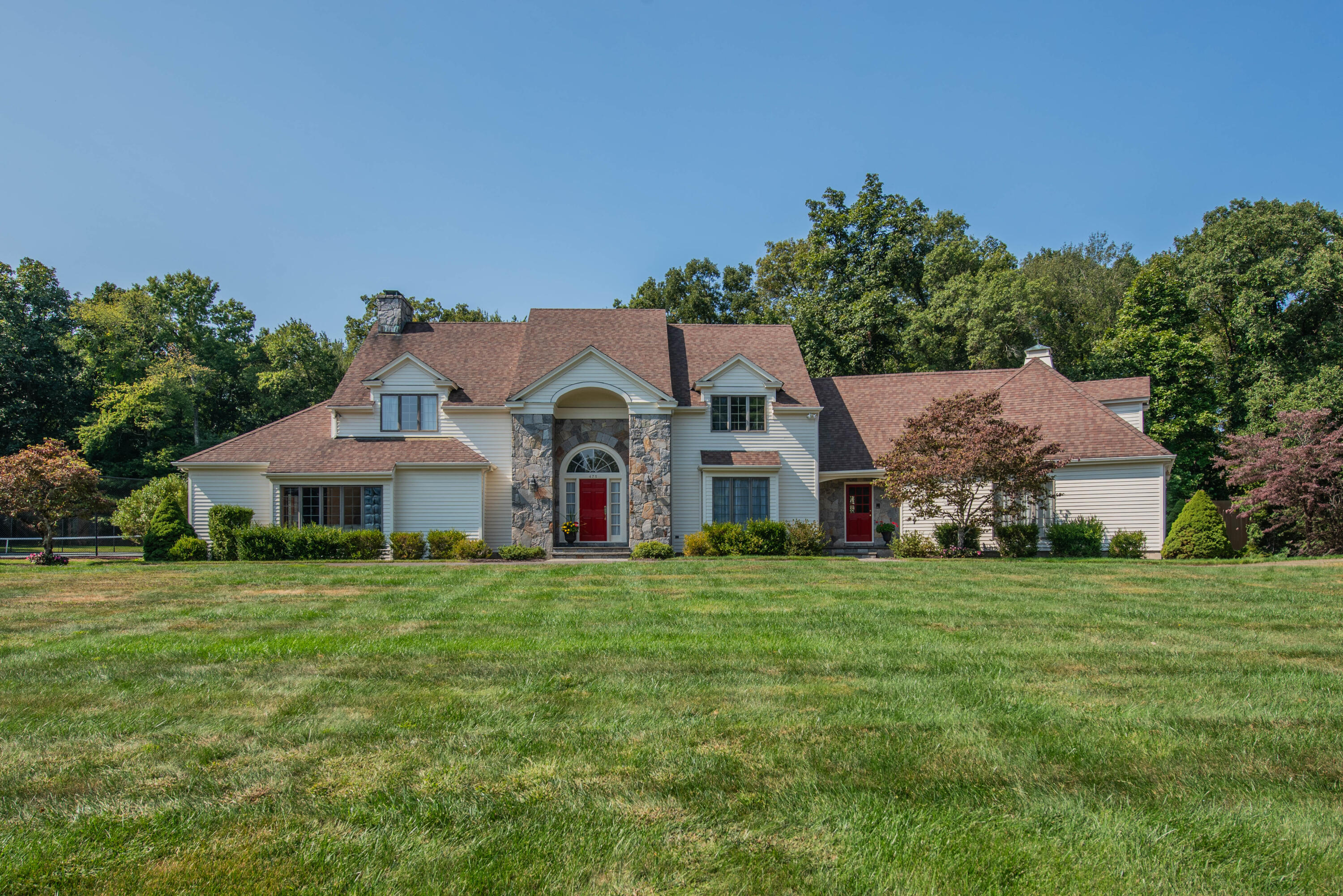 Restricted Address New Canaan, CT 06840 - Photo 1 of 38 a front view of a house with a yard