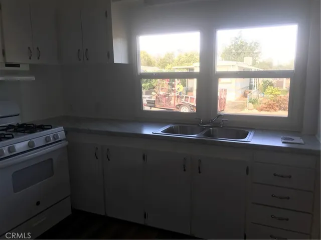 a bathroom with a granite countertop shower and a sink