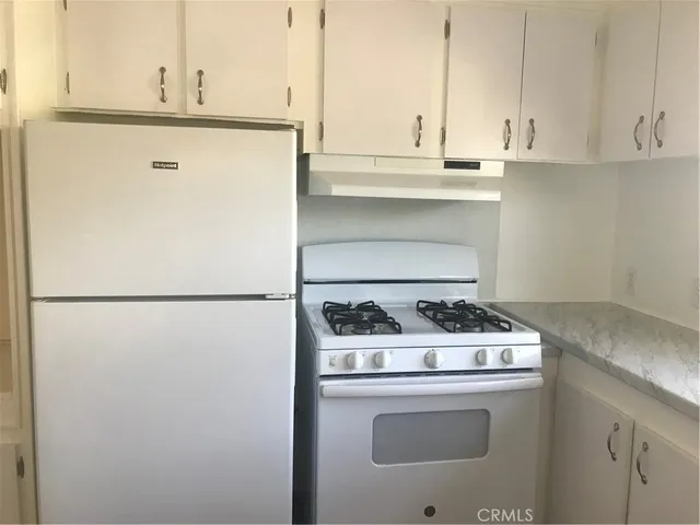 a kitchen with stainless steel appliances a stove and a refrigerator