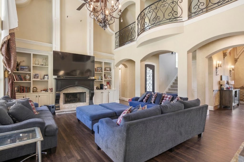 3818 Waterbend Cove Spring, TX 77386 - Photo 5 of 44 a living room with furniture a fireplace and a flat screen tv