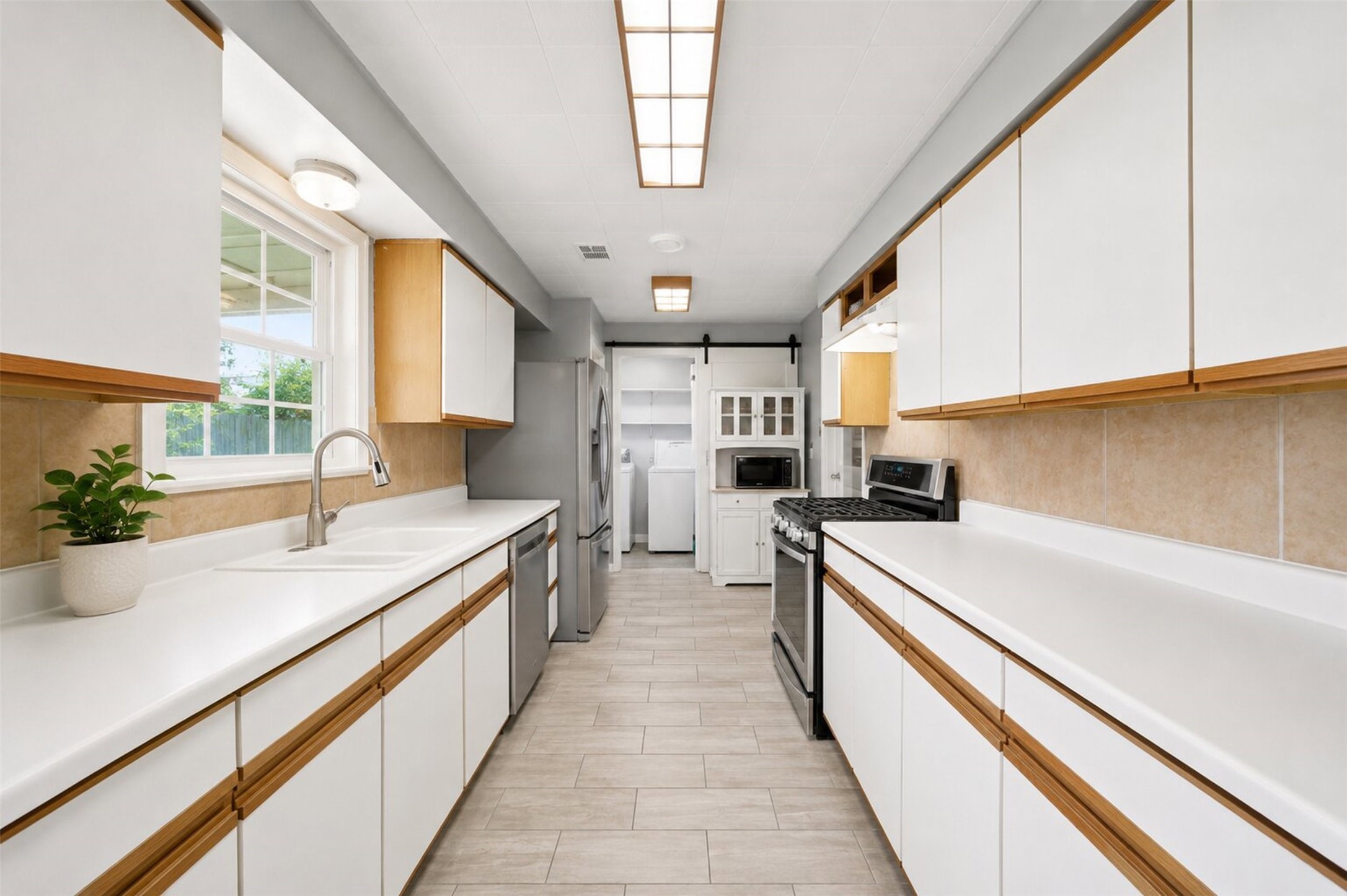 1306 Camden Road Pasadena, TX 77502 - Photo 6 of 16 Spacious galley style kitchen with abundant cabinet space, stainless steel appliances, a large sink, and plenty of counter space for all your cooking needs!