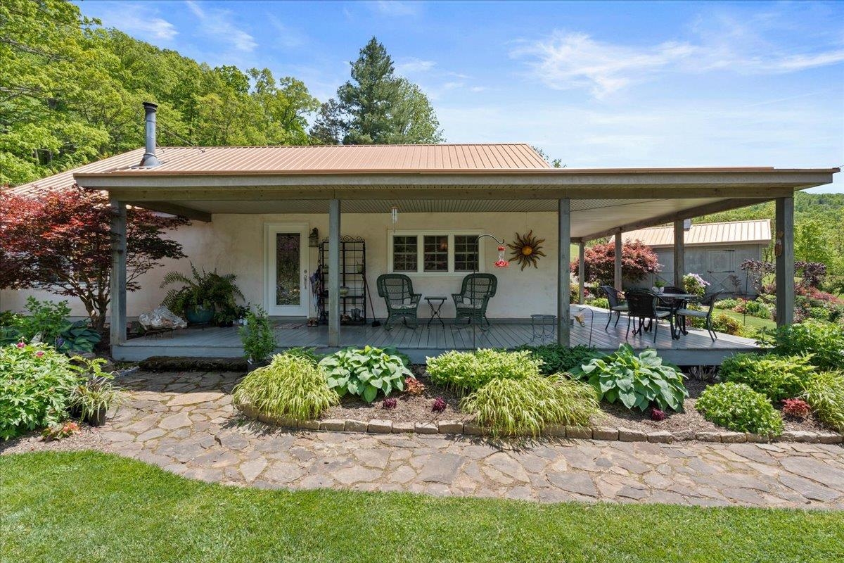 650 Sandy Bottom Road Elkton, VA 22827 - Photo 11 of 75 a view of a house with potted plants and a table and chairs