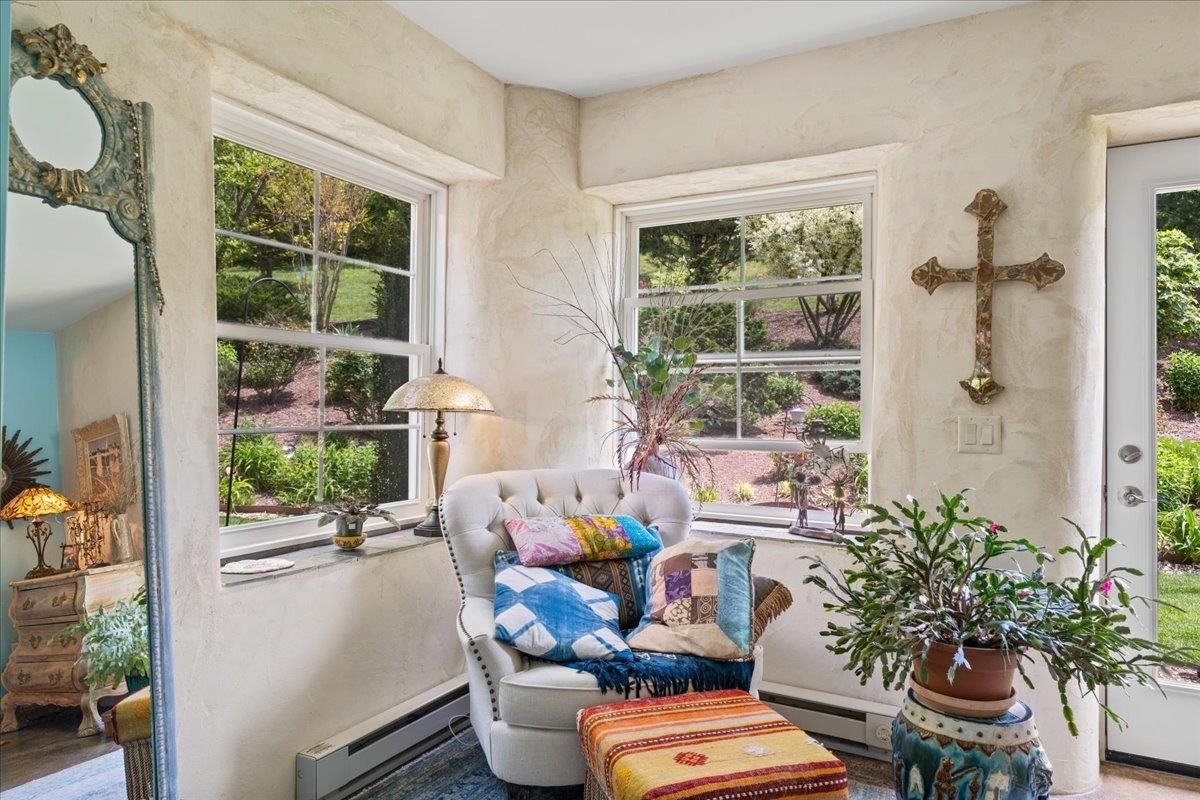 650 Sandy Bottom Road Elkton, VA 22827 - Photo 36 of 75 a room with furniture a potted plant and a large window