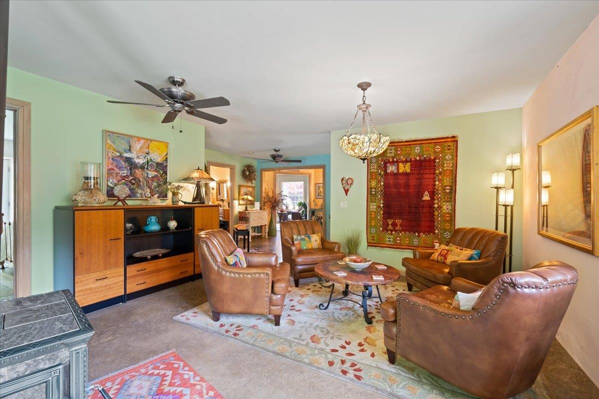 650 Sandy Bottom Road Elkton, VA 22827 - Photo 44 of 75 a living room with furniture a chandelier and a dining table