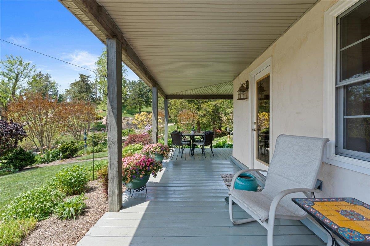 650 Sandy Bottom Road Elkton, VA 22827 - Photo 6 of 75 a view of a patio with table and chairs potted plants with wooden floor and fence