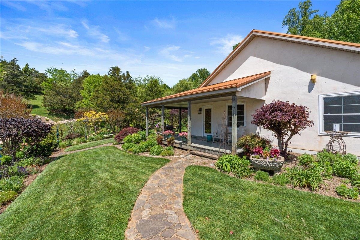 650 Sandy Bottom Road Elkton, VA 22827 - Photo 9 of 75 a front view of house with a garden and patio