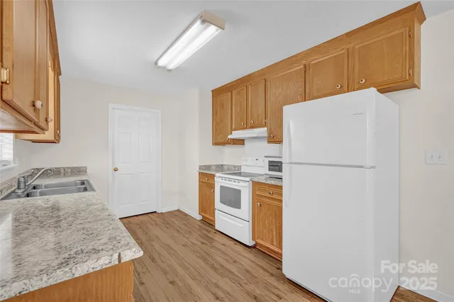 a kitchen with a refrigerator sink and stove
