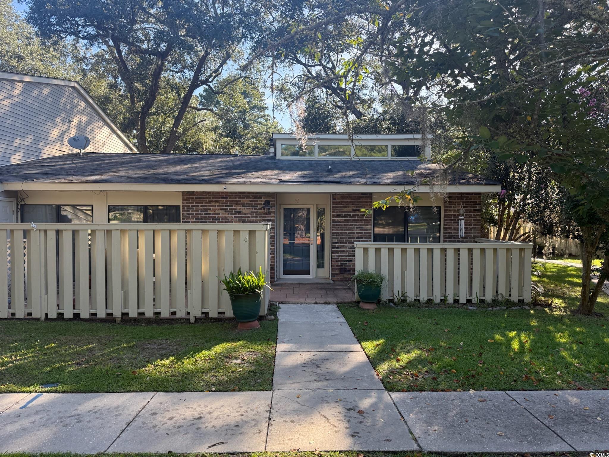 Mid-century inspired home with brick siding and a
