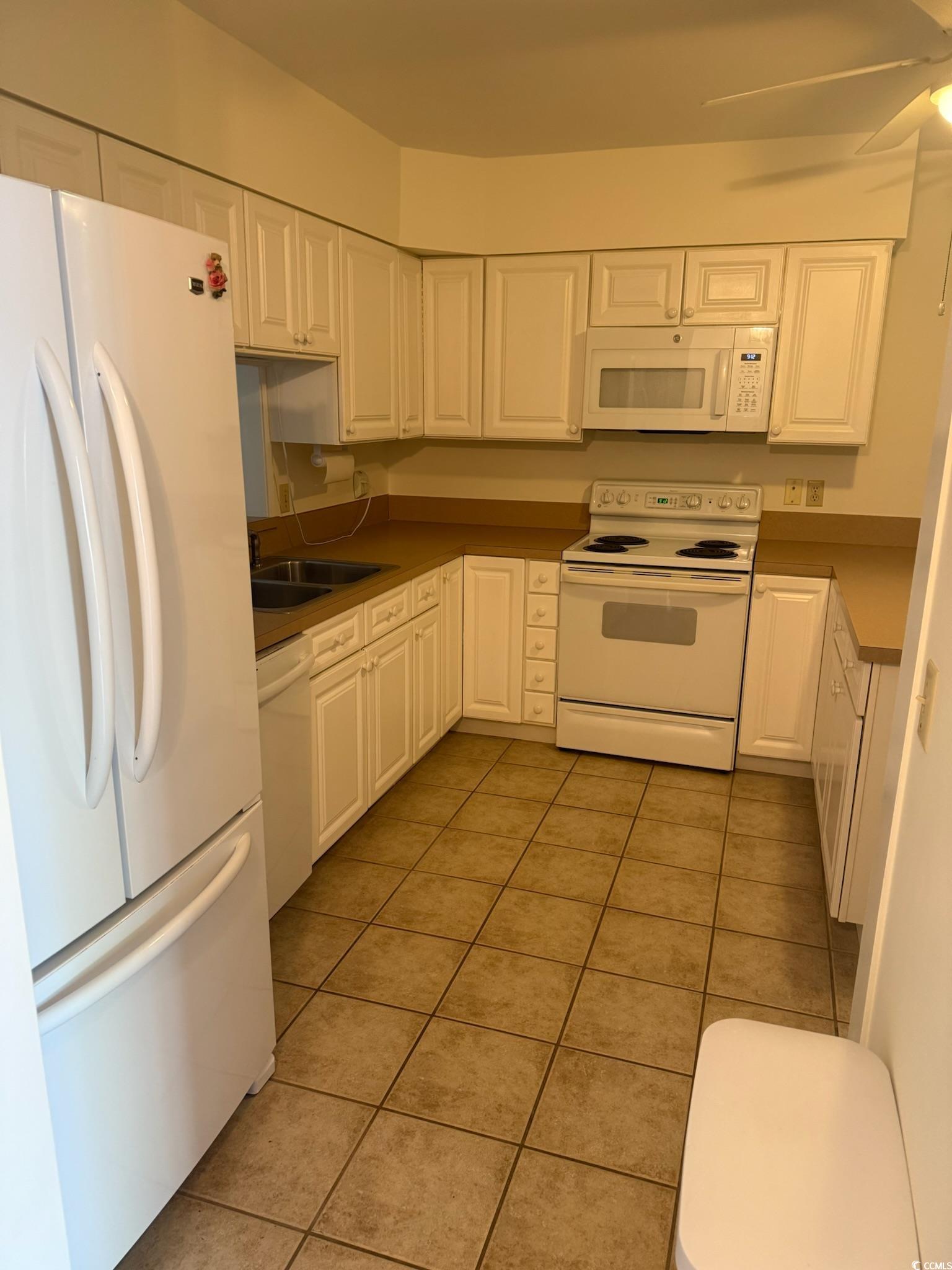 80 Wedgefield Village Road, Unit 46 Georgetown, SC 29440 - Photo 3 of 16 Kitchen featuring white cabinets, white appliances