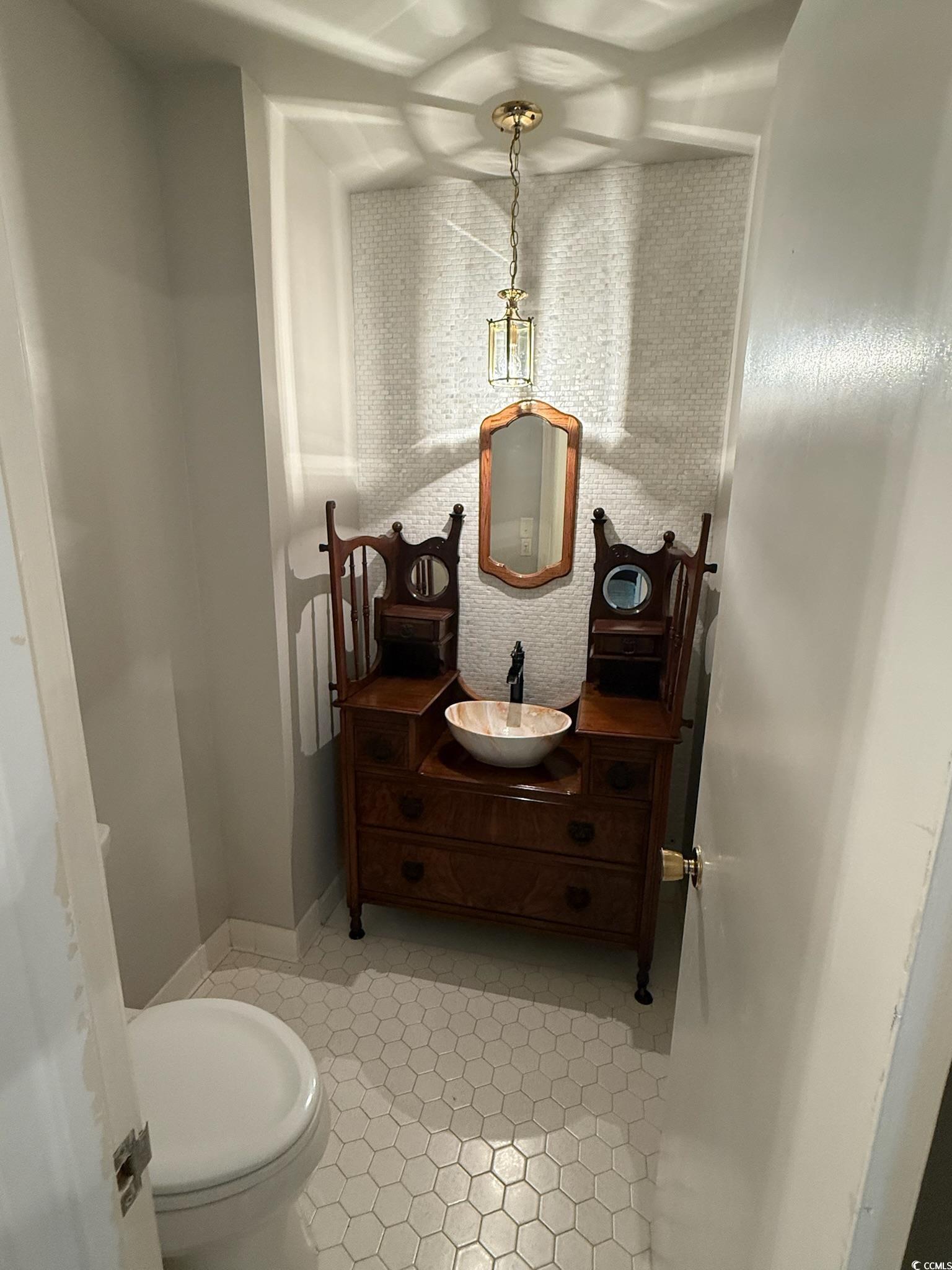 80 Wedgefield Village Road, Unit 46 Georgetown, SC 29440 - Photo 9 of 16 Half bath featuring vanity and light tile patterne