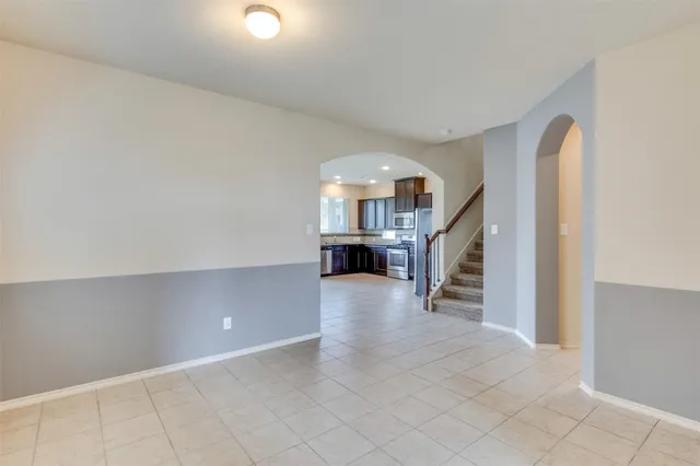 a view of a hallway with workspace and stairs