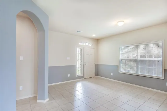 an empty room with windows and closet