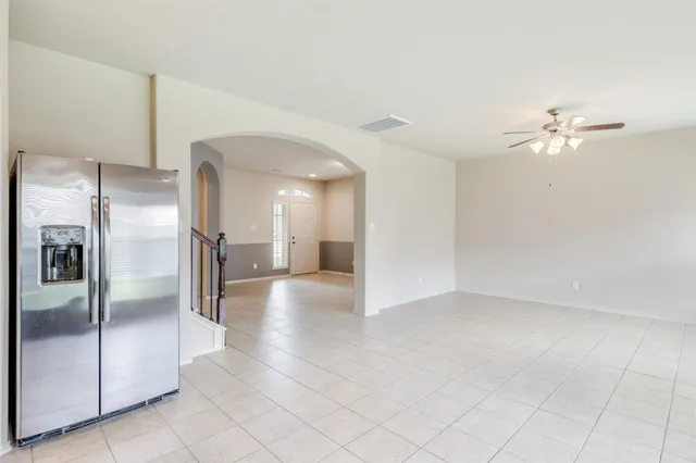 a view of a kitchen with a refrigerator and a chandelier