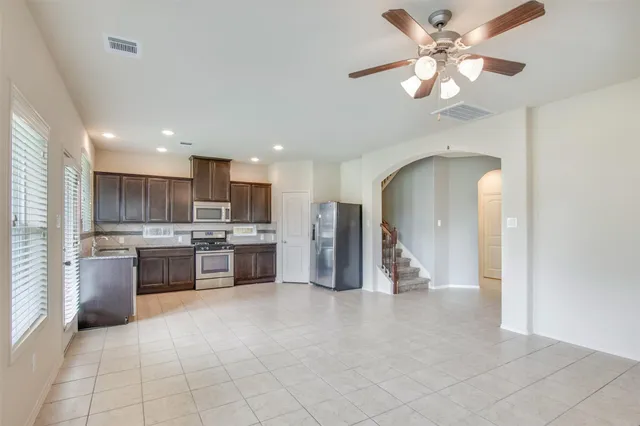 a living room with stainless steel appliances kitchen island granite countertop furniture and a view of kitchen