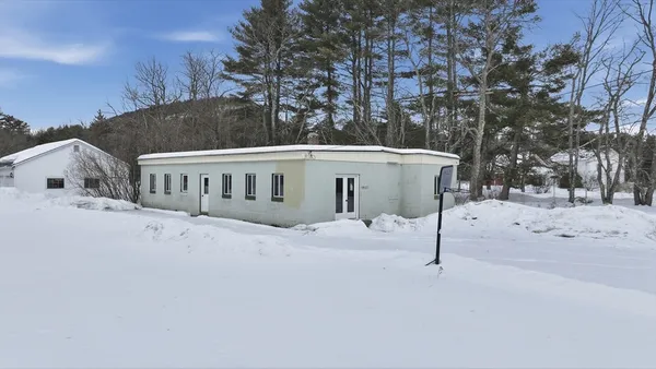 a view of house with a snow in the background